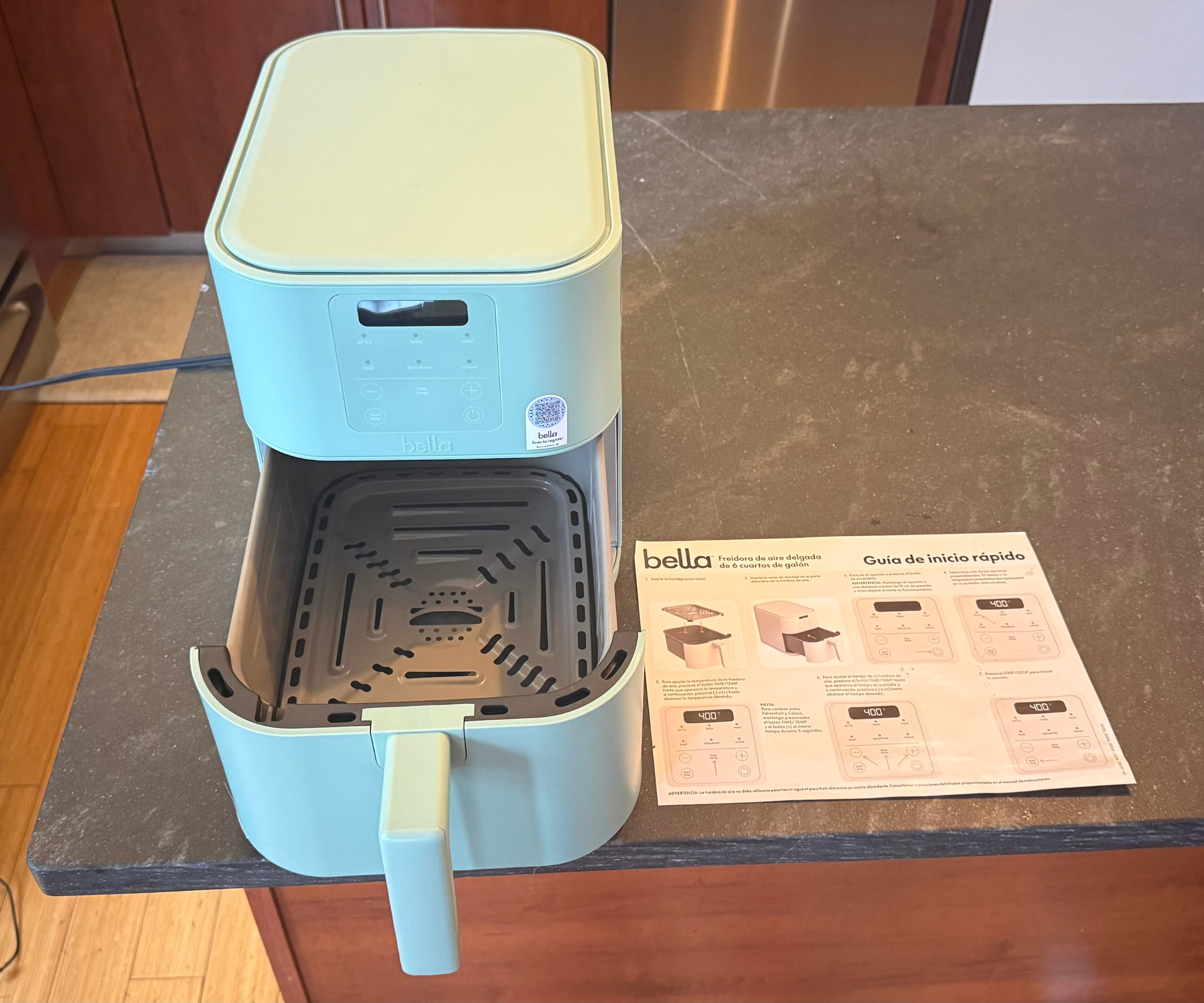 Bella FitsAnywhere 4QT Air Fryer next to the instructions manual