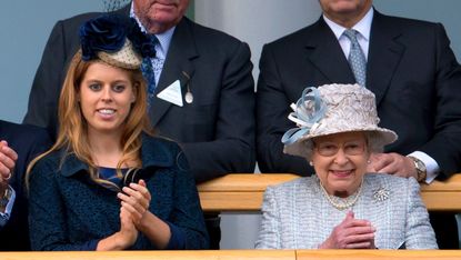 Princess Beatrice of York and Queen Elizabeth II watch Frankel enter the winner's enclosure after winning The QIPCO Champion Stakes at the QIPCO British Champions Day meet at Ascot Racecourse on October 20, 2012 in Ascot, England