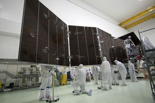 Technicians at Astrotech's payload processing facility in Titusville, Fla. stow solar array #2 against the body of NASA's Juno spacecraft.
