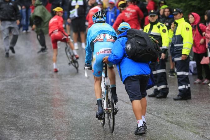 Alessandro Vanotti (Astana) is assisted by a soigneur after finishing stage 14