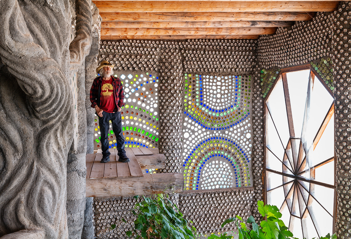 Earthship community in Taos showing colourful off grid homes nestled into the desert earth