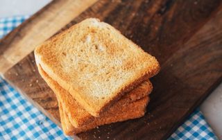 Plain-white-toast on a wooden board