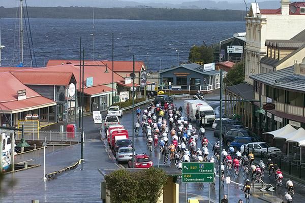 The field in the tour leave the township of Strahan on Tasmania's rugged West Coast bound for Rosebery on stage two.