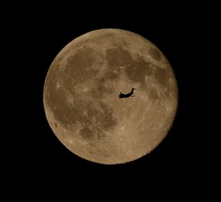 An airplane flies in front of the brilliant Blue Moon full moon of July 31, 2015 in this stunning photo captured by skywatcher Chris Jankowski of Erie, Pennsylvania on July 31, 2015.