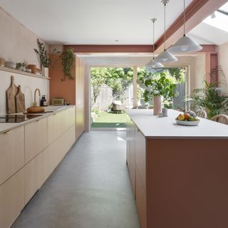 Kitchen with concrete flooring and terracotta island