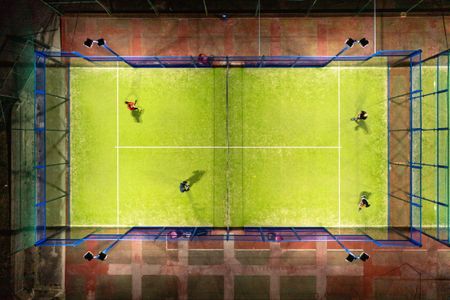 view from above of four padel players on a court