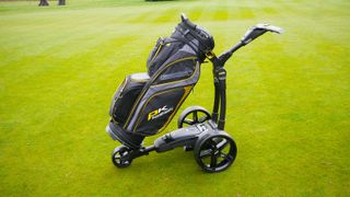 Powakaddy FX3 Electric Trolley with bag attached on grass