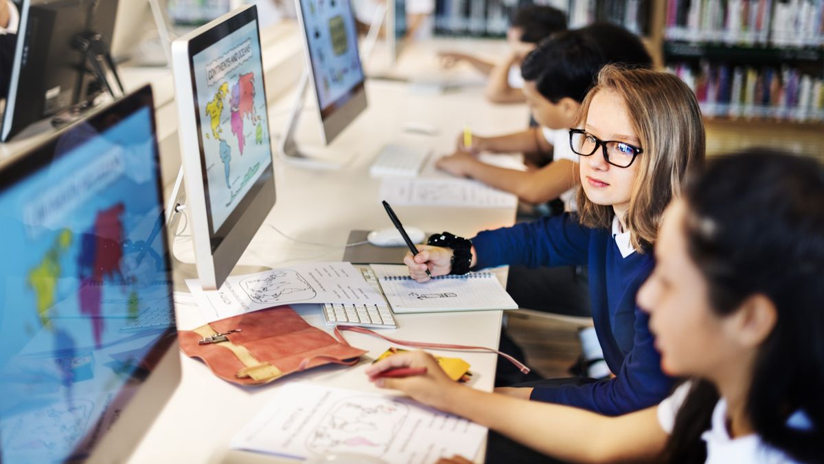 Two students using a PC in a classroom