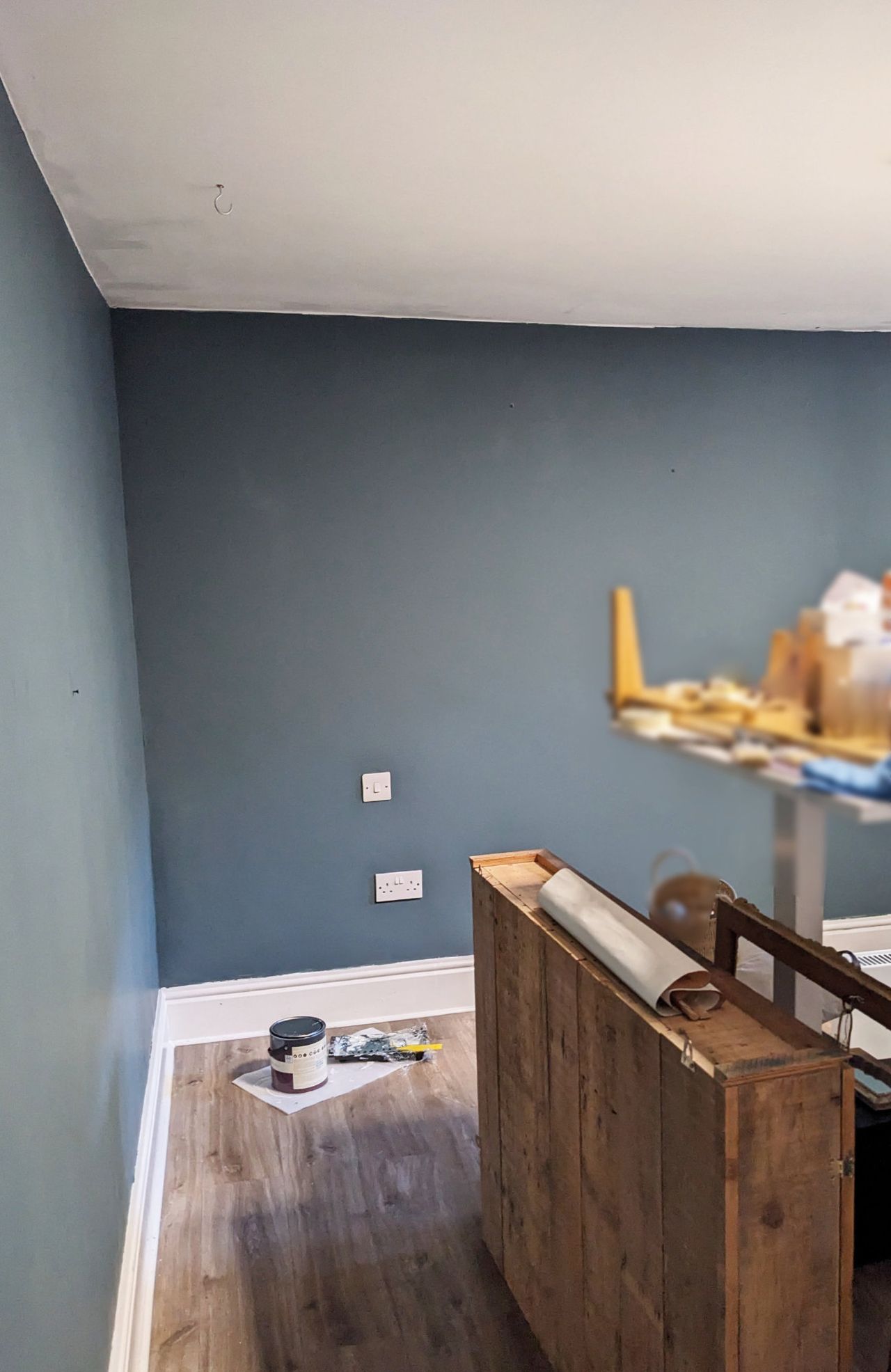 A wall with a second coat of blue paint
