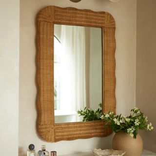 Rattan wavy mirror above bathroom sink