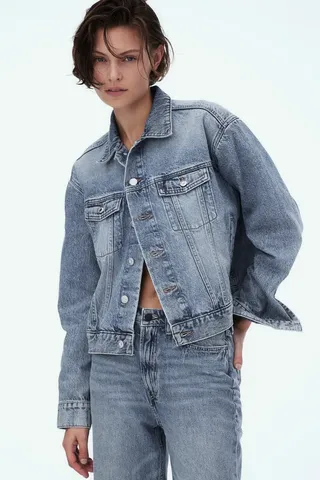 model wears Short Denim Jacket and jeans of a matching wash