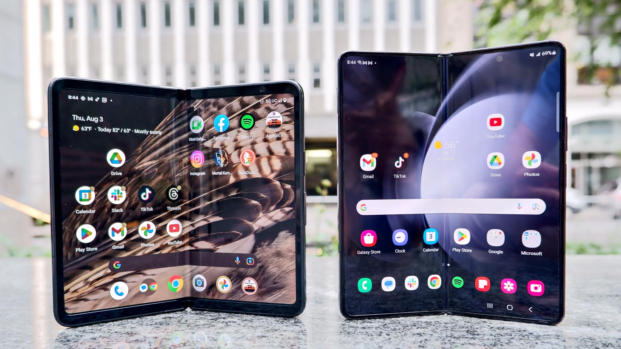 The Google Pixel Fold and Samsung Galaxy Z Fold 5 stand unfolded next to each other.