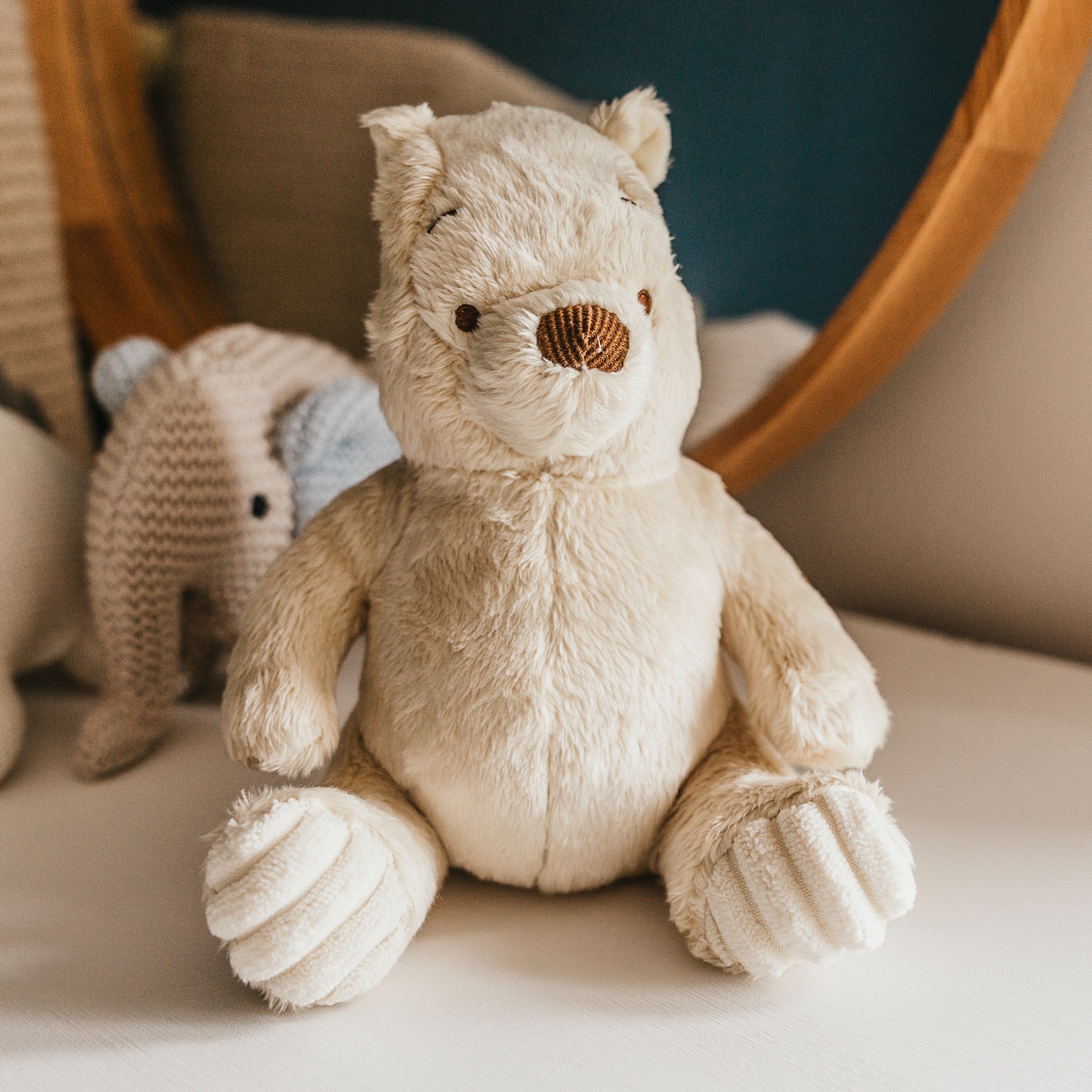 A close-up of a classic Winnie the Pooh baby toy