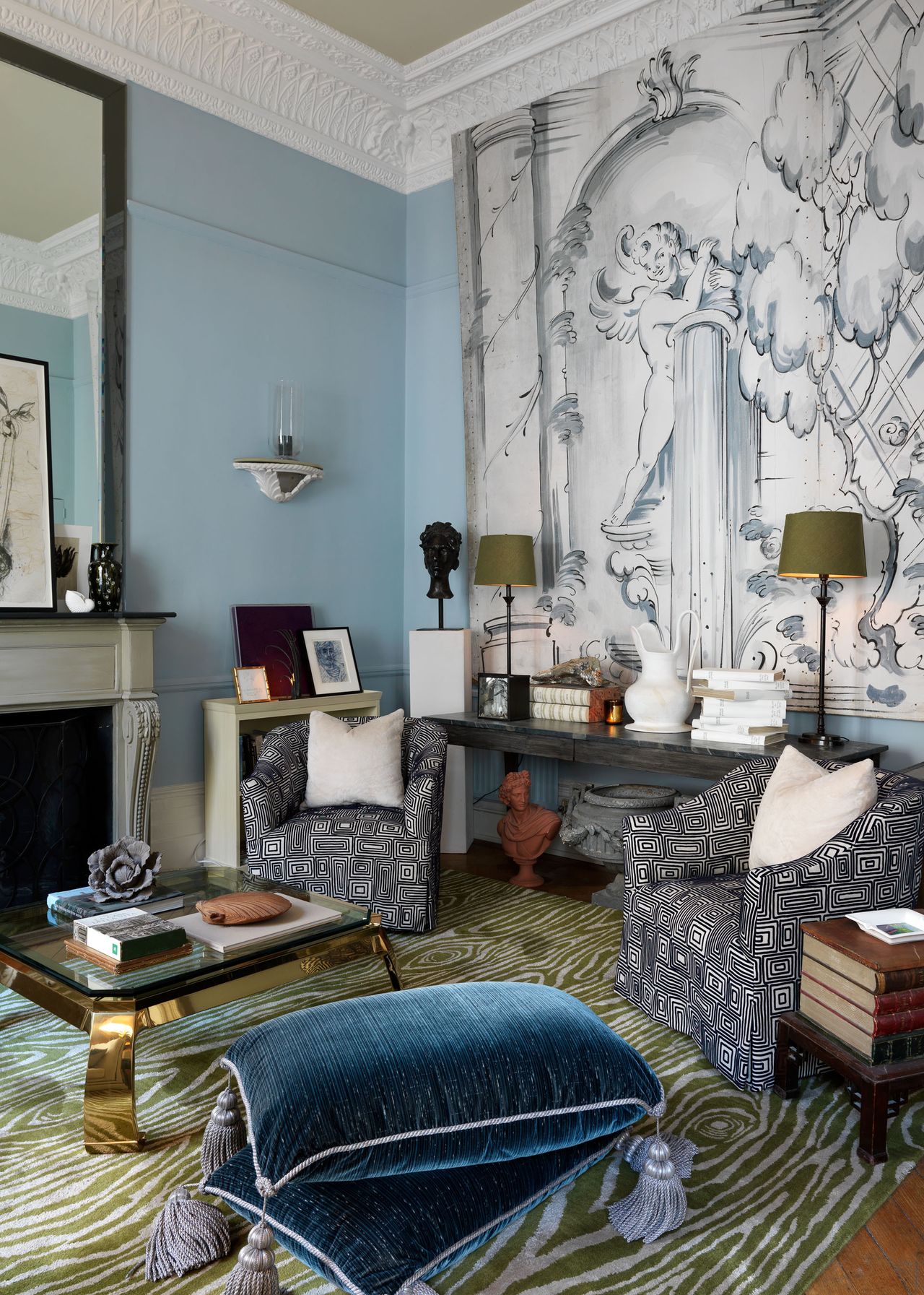 Green wood detail rug, White and grey armchairs and tapestry and blue walls