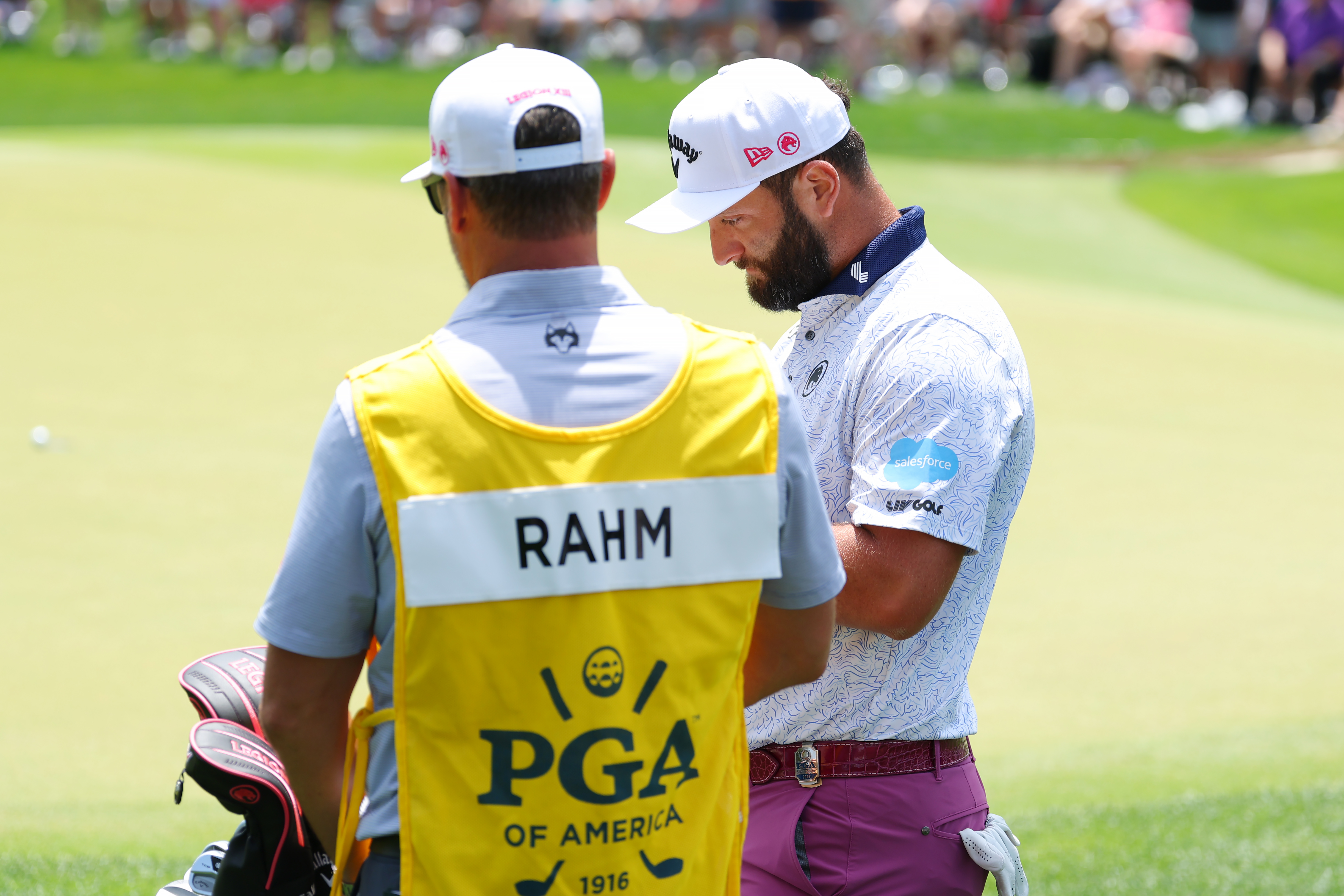 Jon Rahm chats to his caddie