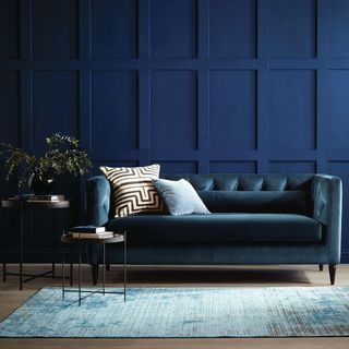 living room with blue sofaset with cushions