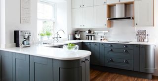 Dark blue grey and white kitchen with marble worktops and kitchen appliances