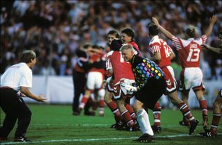 Peter Schmeichel celebrates Denmark's Euro 92 final win over Germany with team-mates and staff.