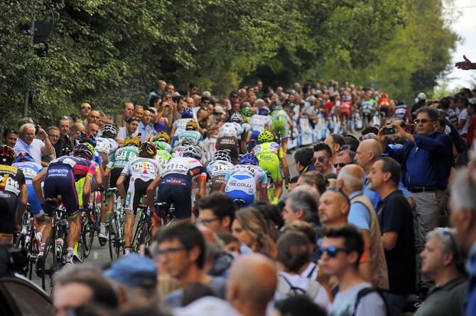 The peloton races up the San Luca climb
