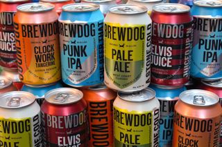 Different types of BrewDog beer cans stacked in a pile
