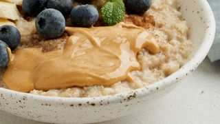 Peanut butter with fruit on porridge