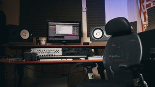 Home recording studio with computer, studio monitors, and various hardware