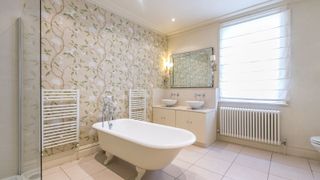 Floral wallpaper in a classically designed bathroom