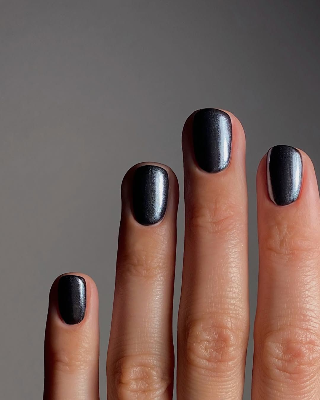 A black metallic manicure by Mateja Novakovic