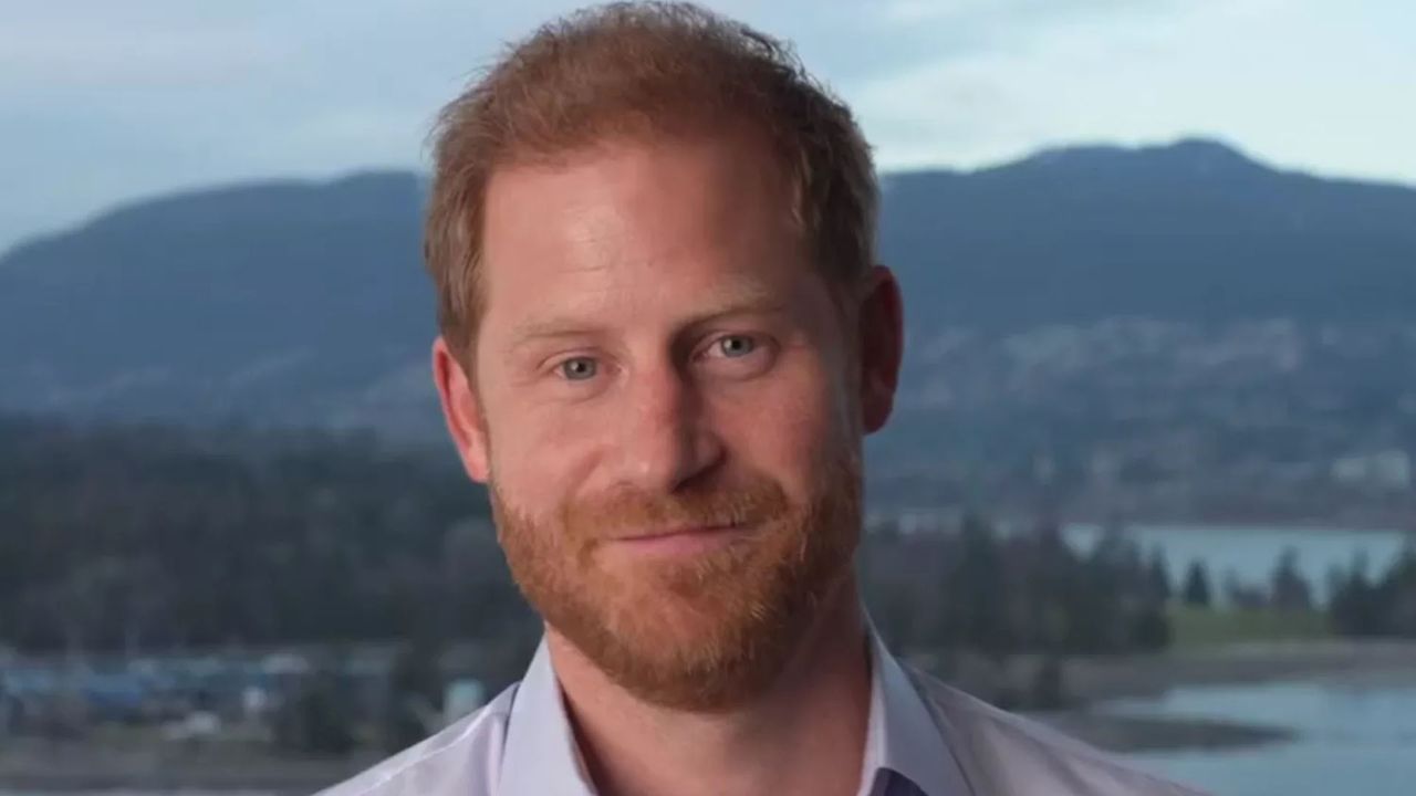 Prince Harry in front of a mountain background