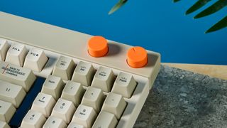 The Lofree Block keyboard on a stone surface with a blue wall in the background.