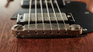 Close up of a wraparound guitar bridge