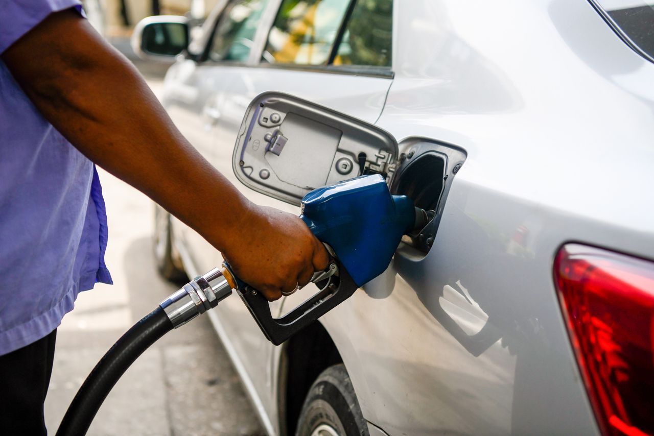 A gas station attendant refuels a car in Dhaka 