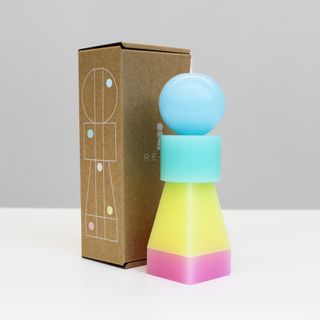 First edition RE-OR interchangeable candle in Percy Pastel, shown with its cardboard packaging.