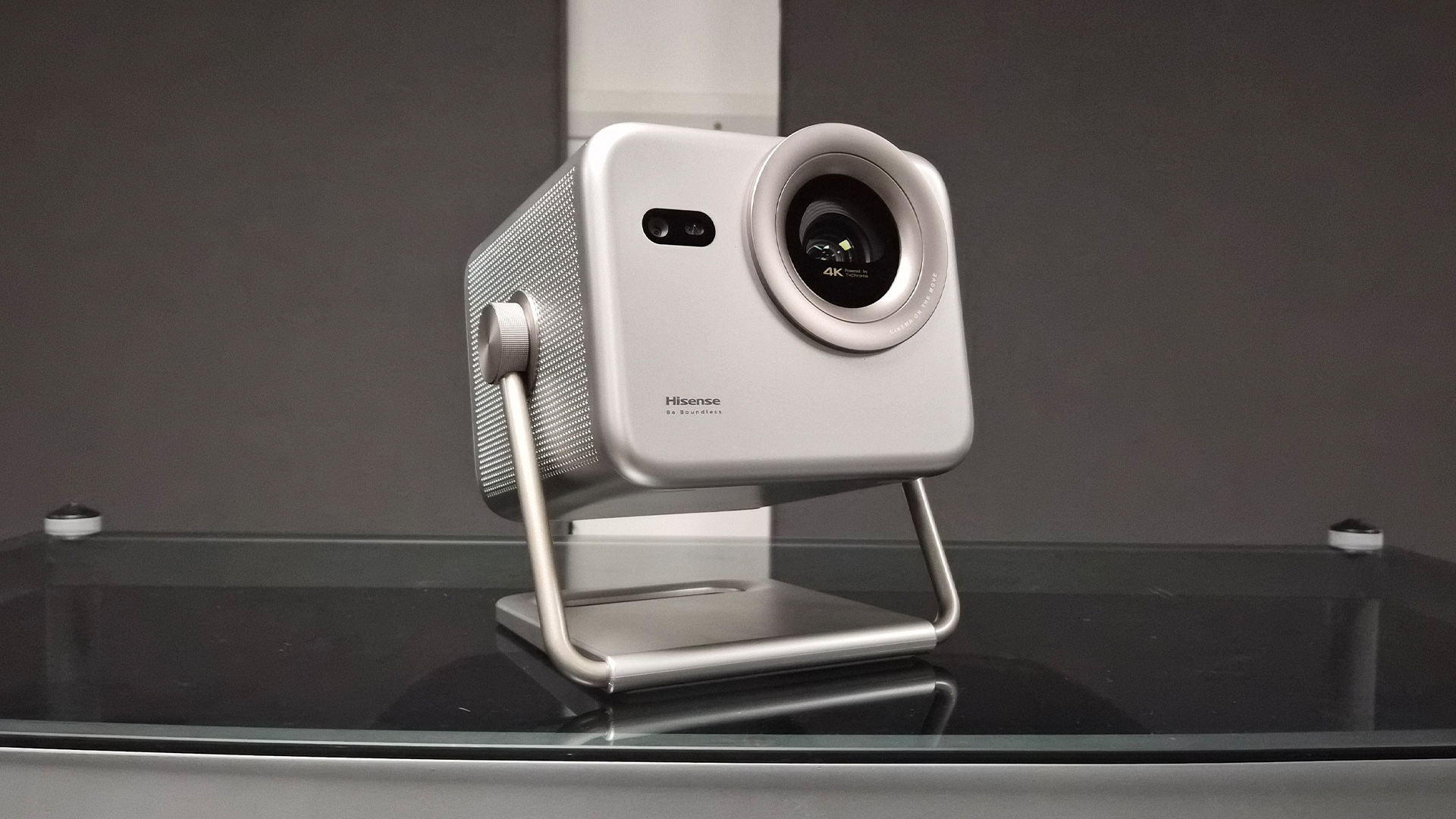 Hisense M2 Pro lifestyle projector on coffee table in front of grey wall