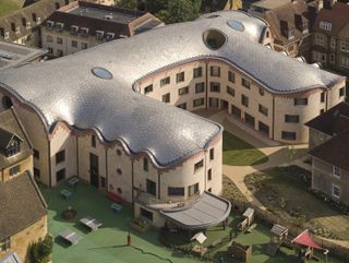 Gradel Quadrangles in Oxford with its pink hued exterior and curved shapes and gargoyles