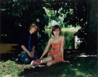 Young teenagers sitting on the grass