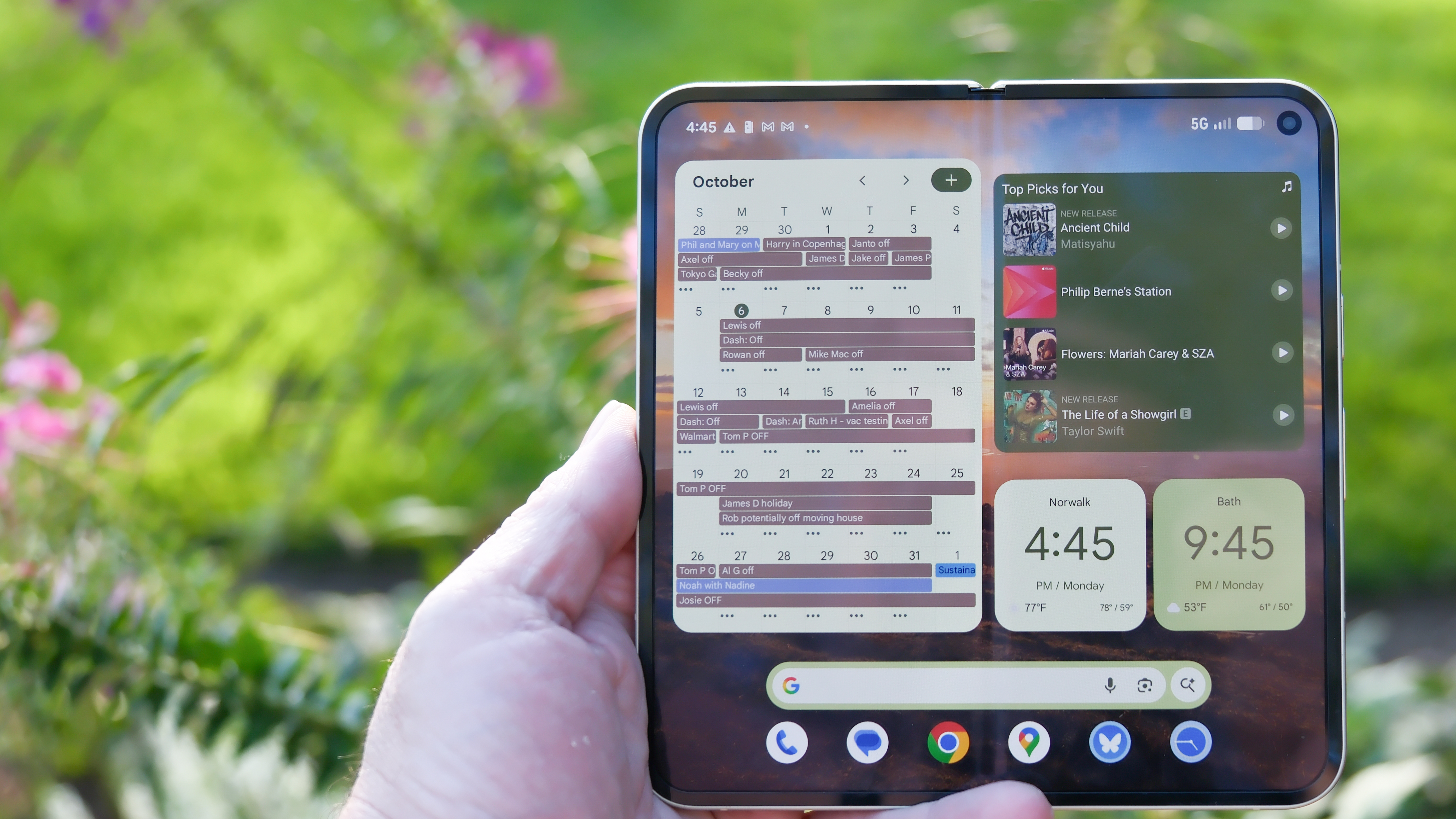 Google Pixel 10 Pro Fold in Jade green outside at a flower garden on a sunny day