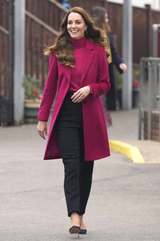 Britain's Catherine, Duchess of Cambridge gestures as she arrives for a visit to Nower Hill High School in Harrow, north London