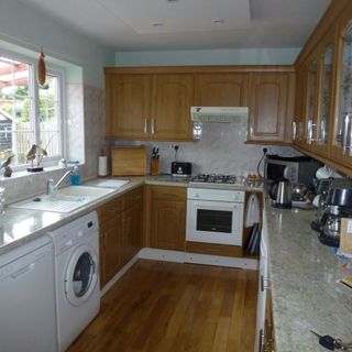kitchen with wooden flooring and microwave