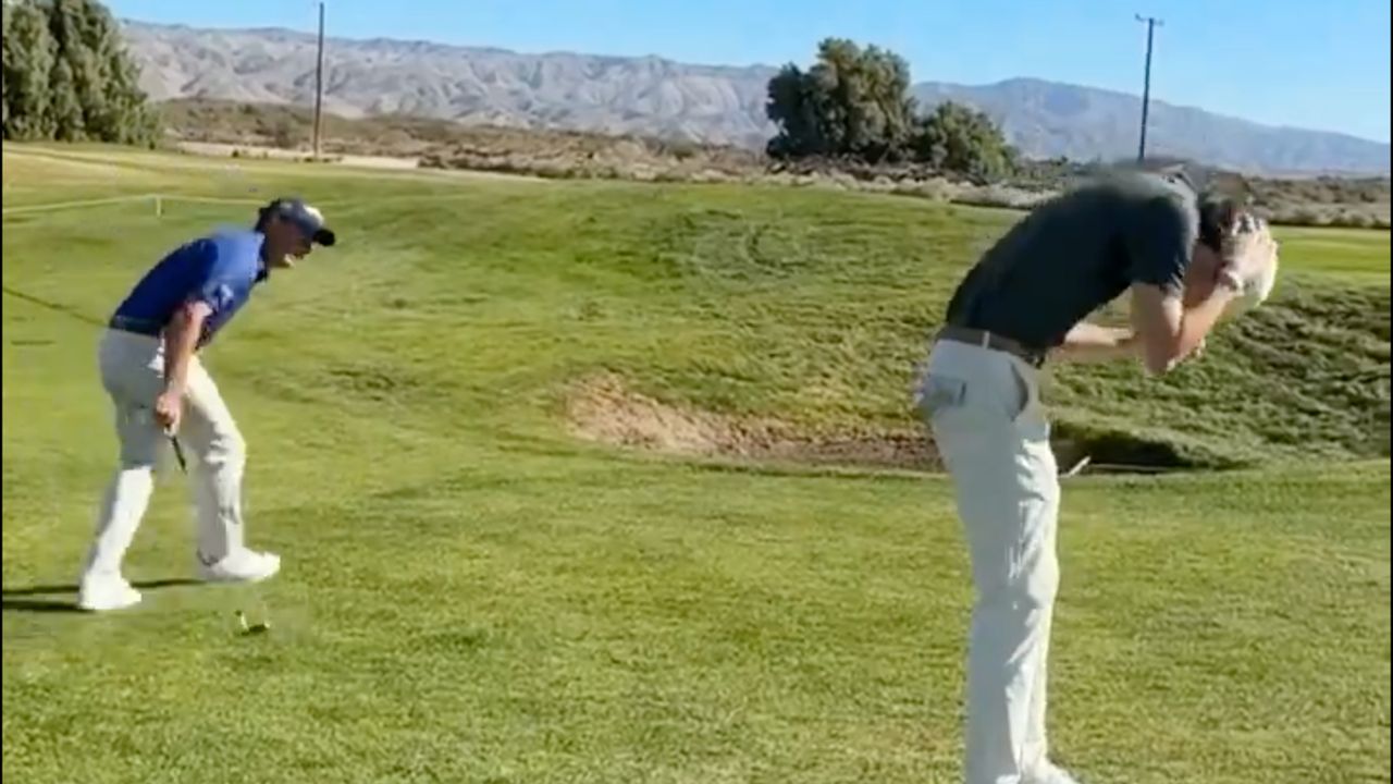 Kevin Kisner peels away laughing after accidentally hitting a golf ball into Ashton Gaulin&#039;s head