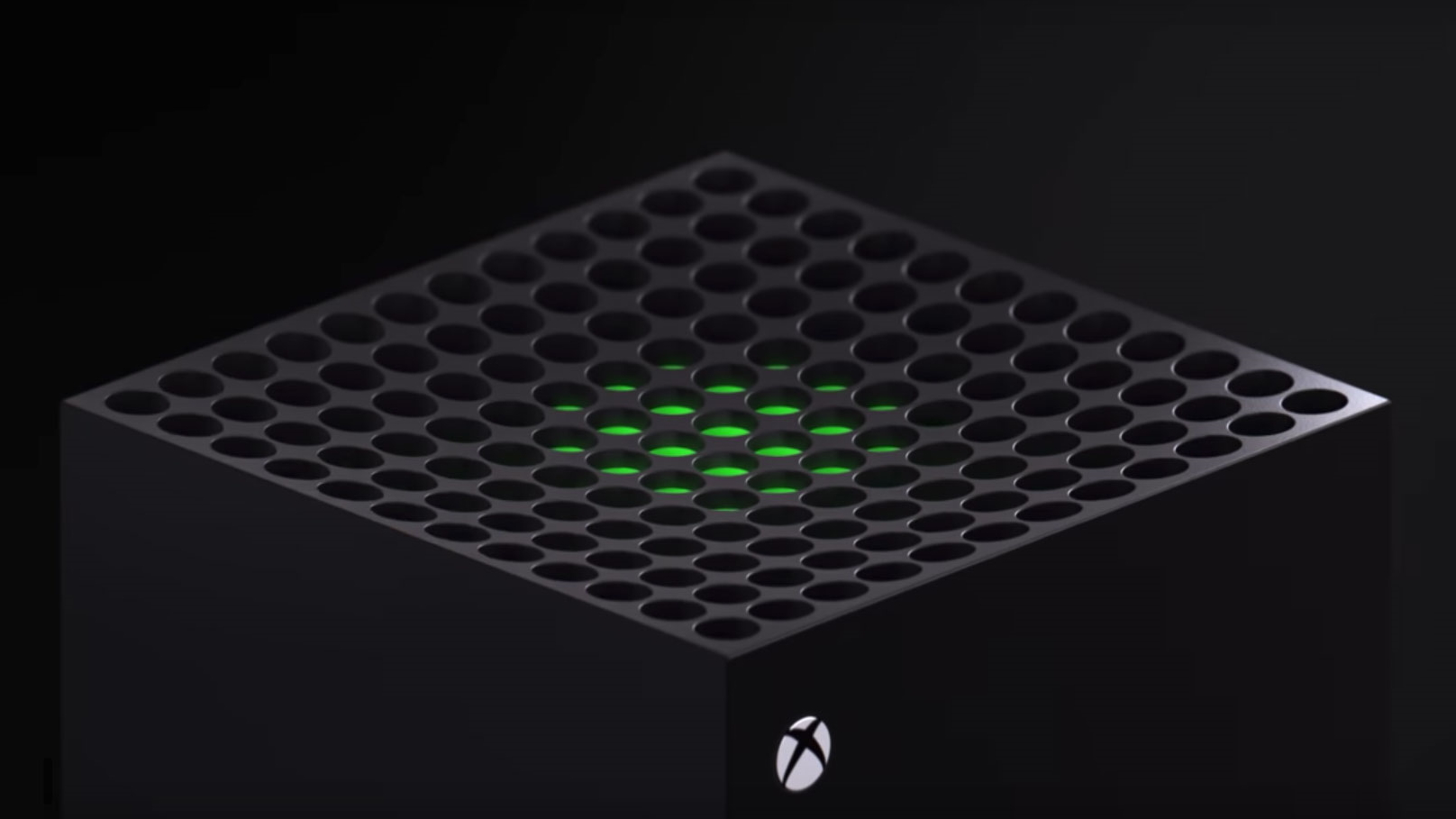 En närbild på ovansidan av en Xbox Series X, med ett grönt svagt ljus som lyser från konsolen och Xbox-logon i ena hörnet.