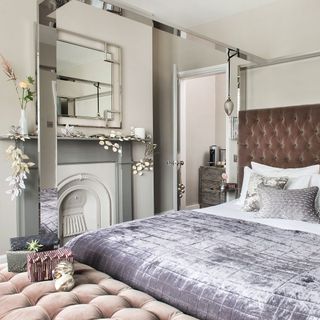 master bedroom with mirrored bed and pink headboard