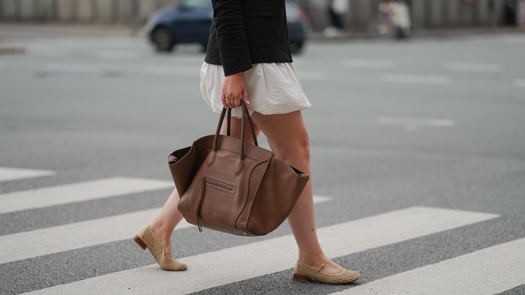 a guest at copenhagen fashion week carrying a celine phantom bag