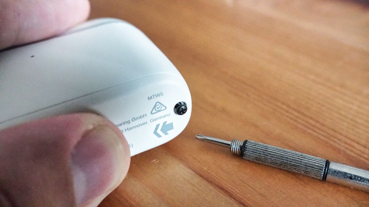 Sennheiser Momentum True Wireless 5 in white, showing details of the buds held in a hand