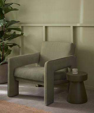 green chair and panelling in living room