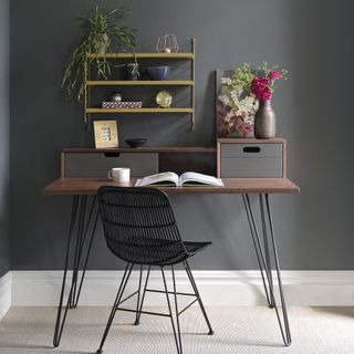 work desk chair with shelves on wall and flower vase