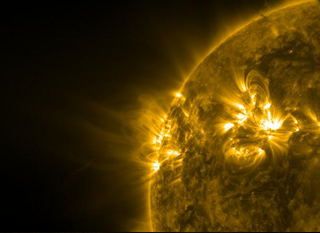 This image, taken by NASA's Solar Dynamics Observatory, shows Comet Lovejoy diving through the sun's atmosphere on Dec. 15, 2011. Lovejoy's tail is visible as a faint diagonal smudge to the left of the sun, toward the bottom of the image. The tail points from lower left to upper right.