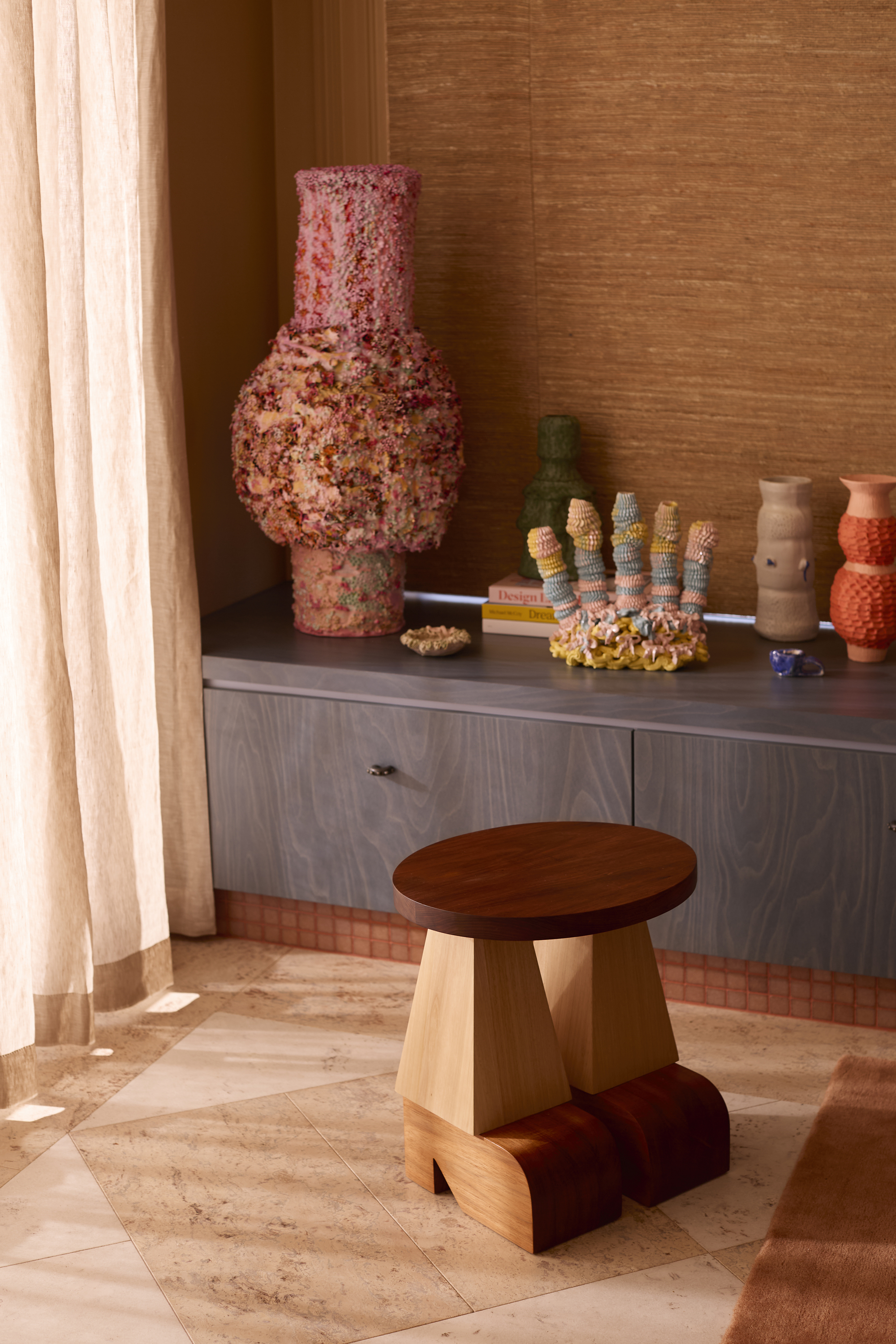 a collection of ceramics on a timber built-in cabinet