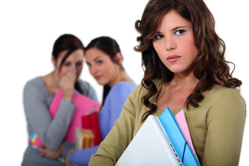 woman being whispereda bout behind her back