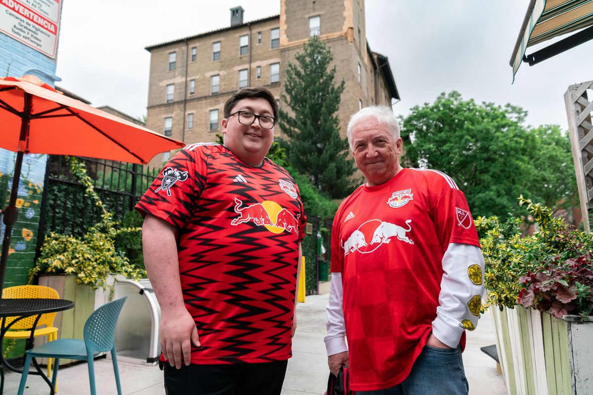 New York Red Bulls fans Andrew and Ian Pollock pose outside a restaurant in Queens, New York